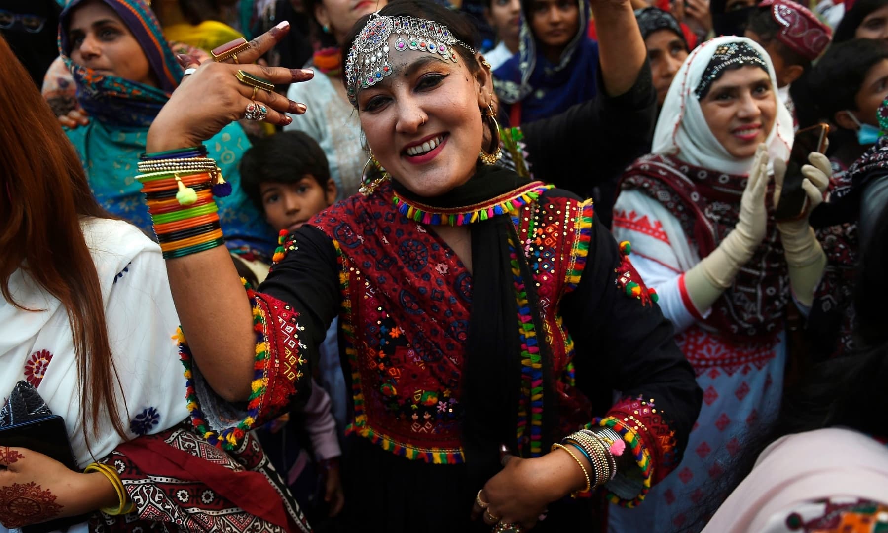 People wearing traditional dresses gather to celebrate the Sindh Culture Day in Karachi. — AFP