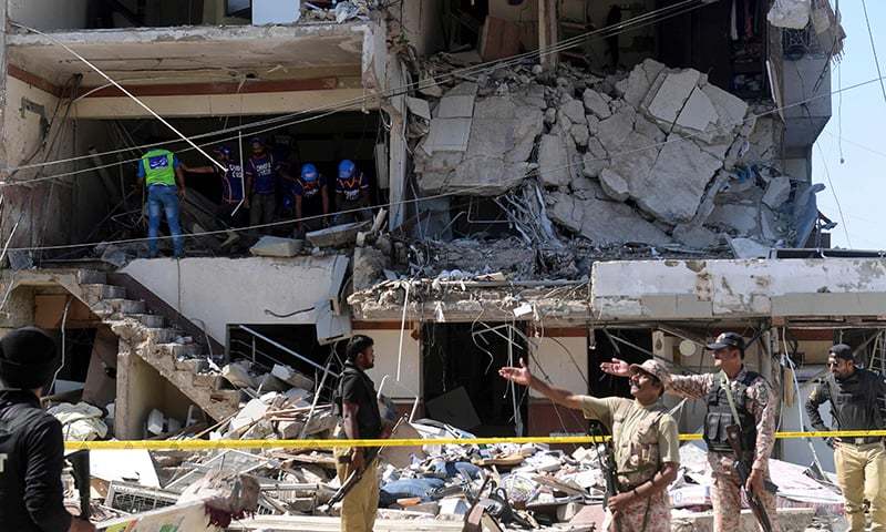 Security personnel and rescue workers are seen amid the debris of a multi-storey building that was damaged after an explosion in Karachi on October 21. — AFP/File Security personnel and rescue workers are seen amid the debris of a multi-storey building that was damaged after an explosion in Karachi on October 21. — AFP/File