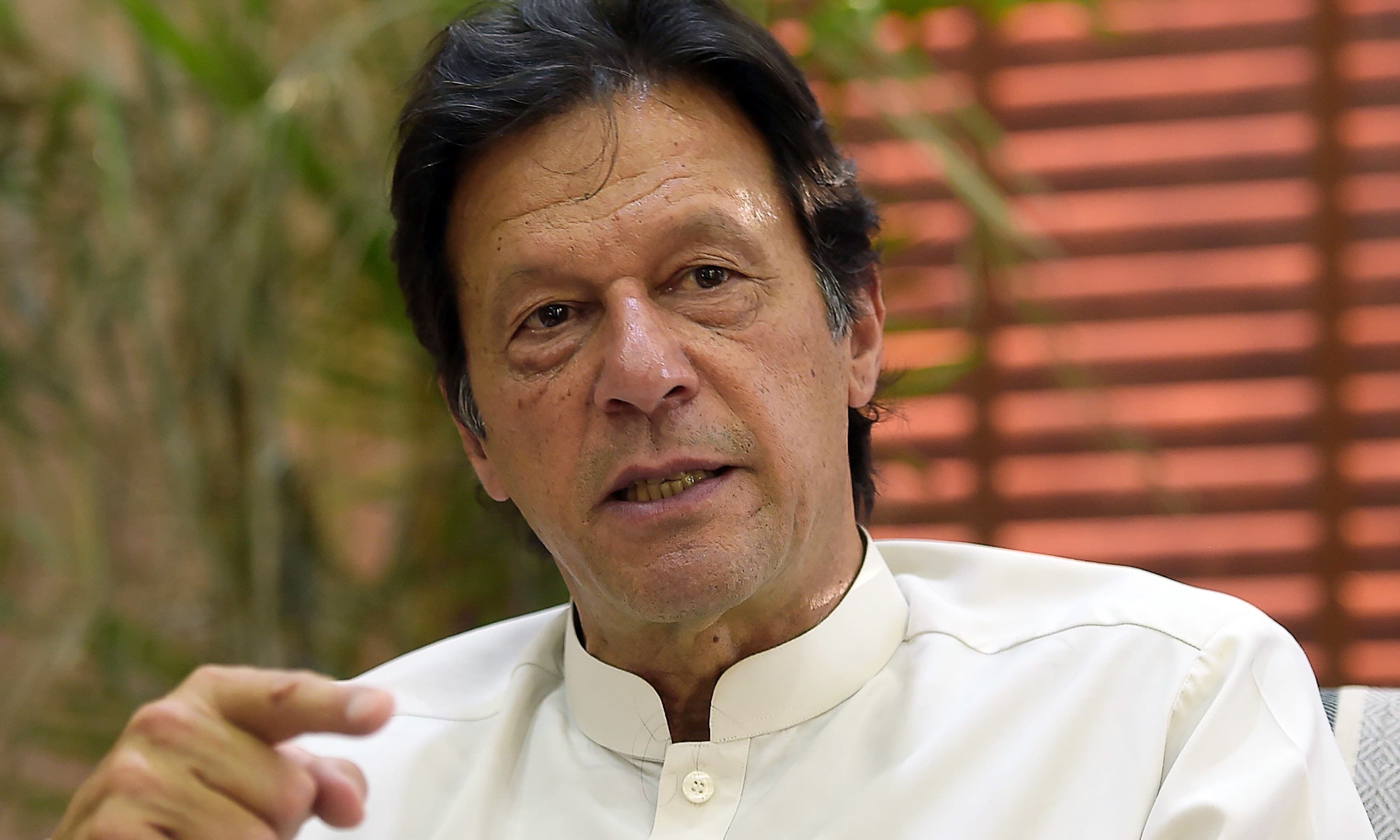 In this picture taken on May 24, 2018, Prime Minister Imran Khan speaks during an interview with AFP at his home in Islamabad. — AFP