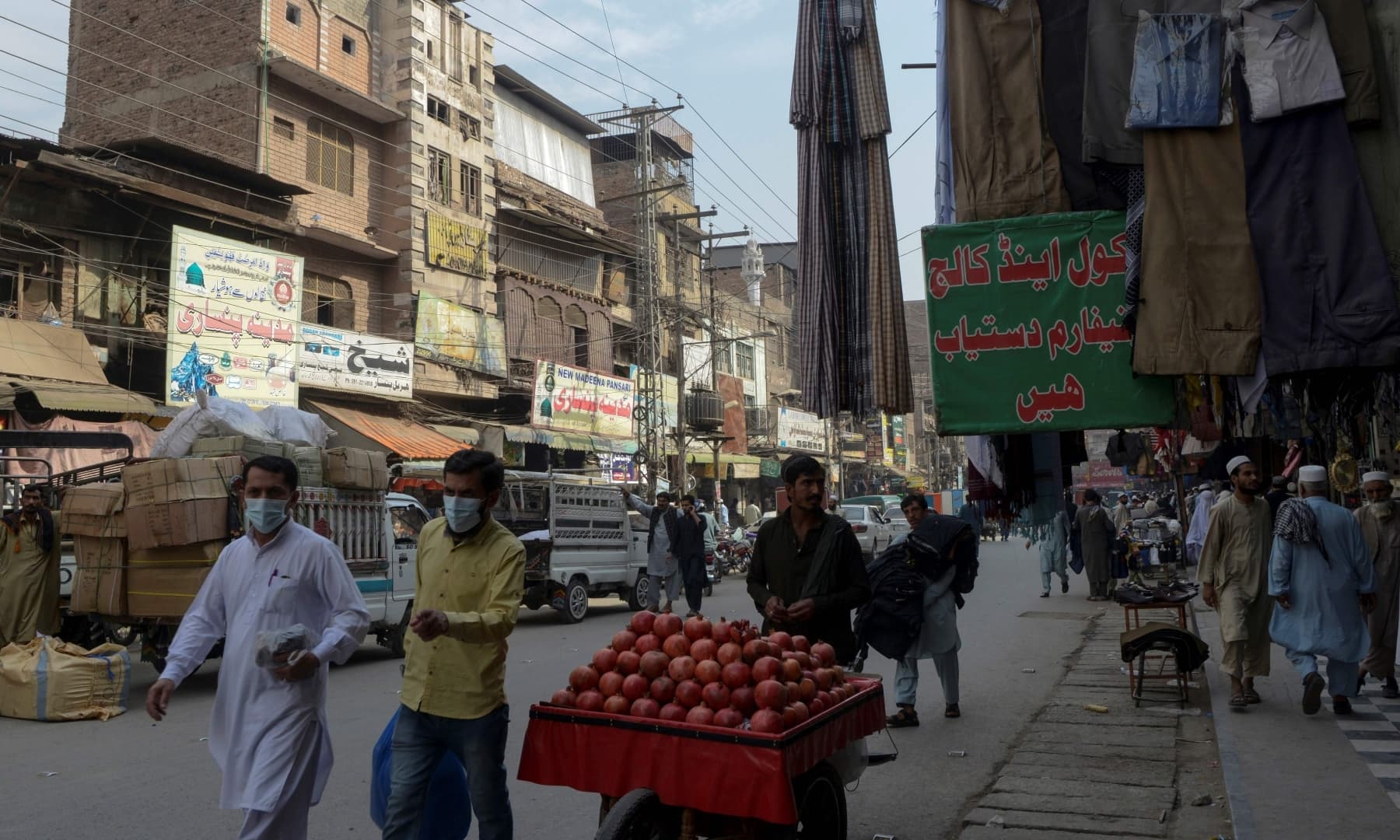 Residents walk through the Qissa Khawani or “storytellers bazaar” in Peshawar. — AFP