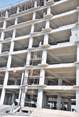 LABOURERS carry out work at an under-construction plaza in Islamabad.—APP