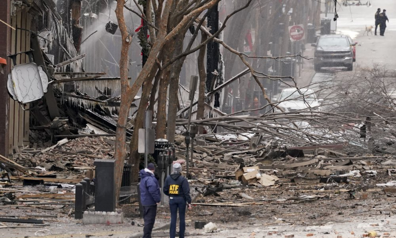 Emergency personnel work near the scene of an explosion in downtown Nashville, United States on Friday. &mdash; AP