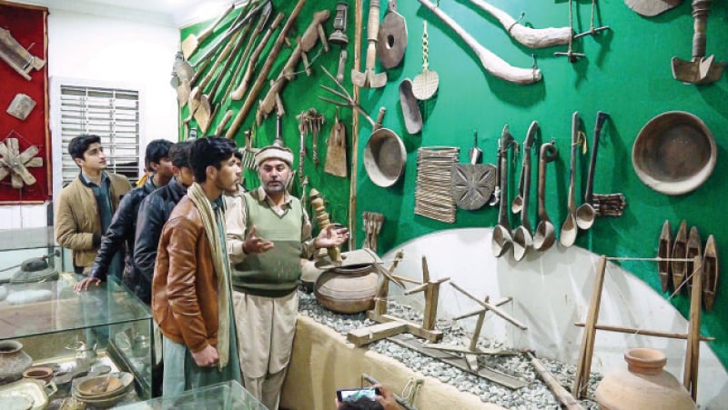 Amir Khaliq briefs visitors at his museum in Salampur village, Swat. — Dawn