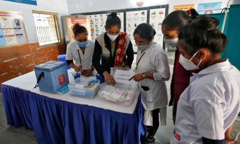 Health workers prepare a vaccination room inside a classroom of a school, which has been converted into a temporary Covid-19 vaccination centre in Ahmedabad, India on Jan 4. — Reuters