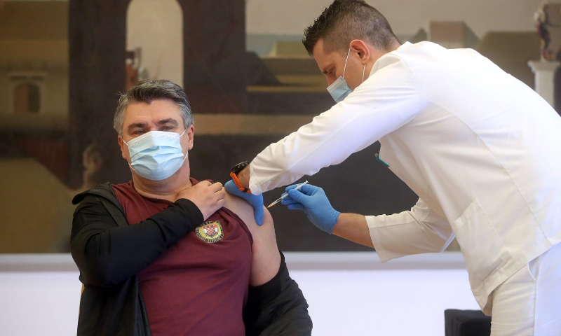A medical worker administers a Covid-19 vaccine shot to Croatian President Zoran Milanovic in Zagreb on Thursday. — AFP