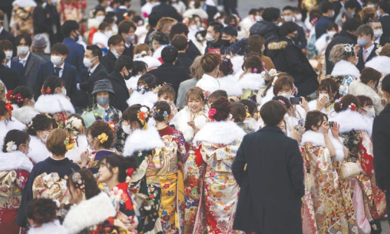 KAWASAKI (Japan): Twenty-year-old men and women, dressed in kimonos, gather outside an arena during a “coming-of-age day” ceremony on Monday.—AFP