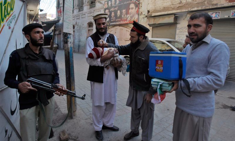 A file photo shows a polio worker administering vaccination to a baby. — Dawn archives