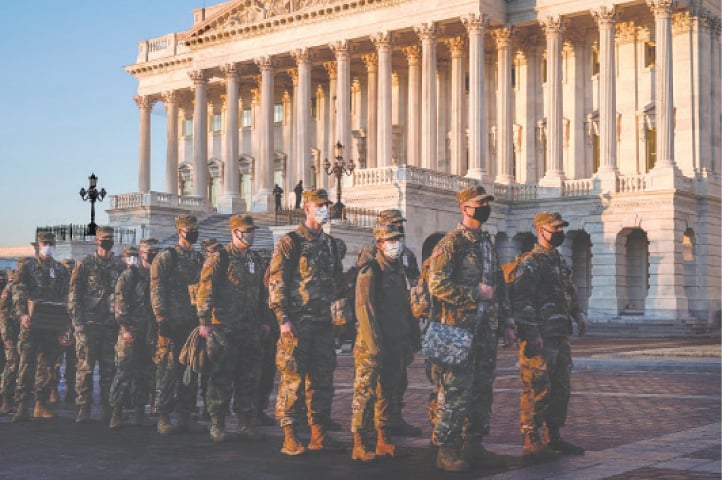 WASHINGTON: Members of the National Guard arrive at the US Capitol as Democratic members of the House prepare articles of impeachment against President Donald Trump on Tuesday.—Reuters