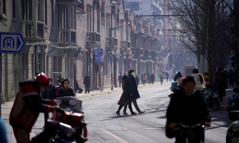 A man wearing a face mask crosses a street following the coronavirus disease outbreak, in Shanghai, China Jan 14, 2021. &mdash; Reuters