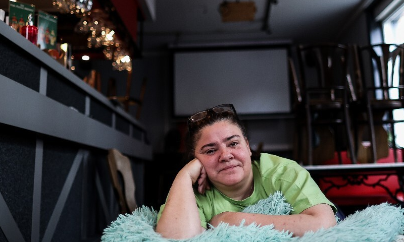 Christelle Carion lies on her makeshift bed in her cafe. — AFP