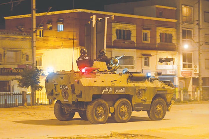 PERSONNEL of the Tunisian National Guard sit atop their armoured vehicle along a street amid clashes with demonstrators.&mdash;AFP