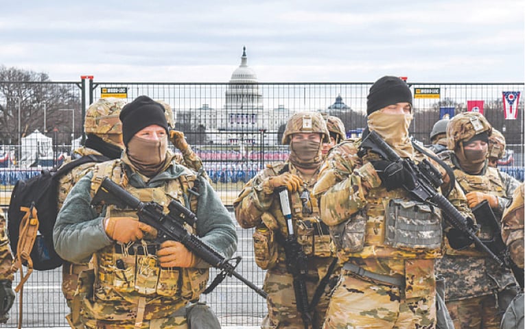 WASHINGTON: Members of the National Guard patrol the National Mall on Tuesday. Tight security measures are in place for Joe Biden’s inauguration due to greater security threats after the attack on the US Capitol on Jan 6.—AFP