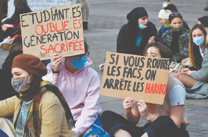 TOULOUSE (France): Students of the University of Toulouse hold placards reading “Forgotten students, sacrificed generation” during a demonstration to demand the resumption of on-site classes.—AFP