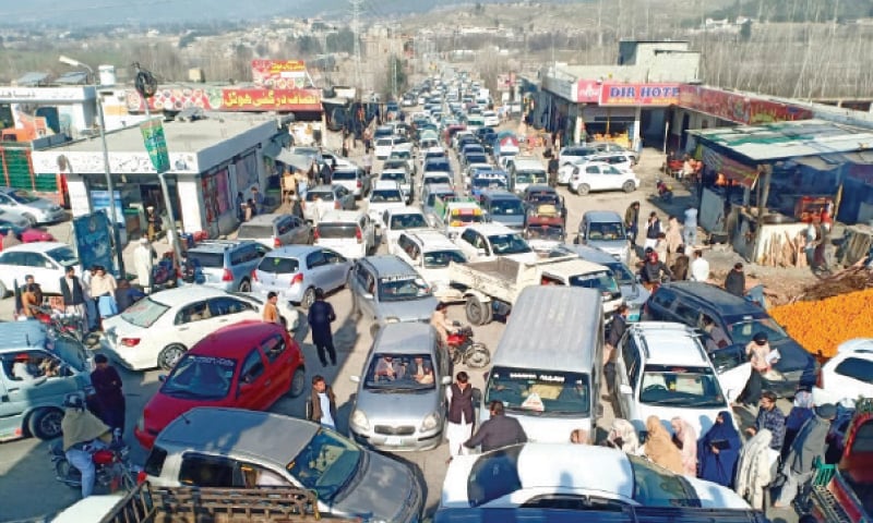 Motorists stuck in a major traffic jam in Lower Dir on Sunday due to large number of visitors outside an NTS test centre. — Dawn Motorists stuck in a major traffic jam in Lower Dir on Sunday due to large number of visitors outside an NTS test centre. — Dawn