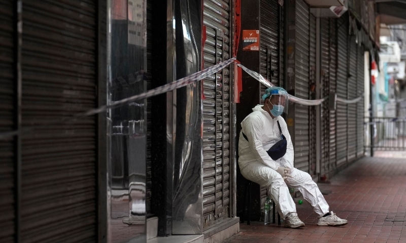A government worker wearing personal protective equipment guards at the closed area in Jordan district, in Hong Kong, on Jan 24. &mdash; AP