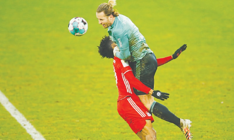 GELSENKIRCHEN: Schalke 04 goalkeeper Ralf Fahrmann collides with Kingsley Coman of Bayern Munich during their Bundesliga match at Veltins Arena.—Reuters