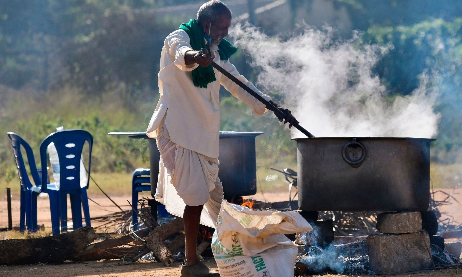 A farmer prepares breakfast for protestors as they continue to demonstrate against the central government's recent agricultural reforms, in Bangalore on January 26. — AFP