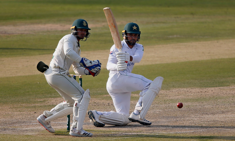 Faheem Ashraf follows the ball after playing a shot for boundary while Quinton de Kock watches during the second day of the first cricket Test match between Pakistan and South Africa at the National Stadium in Karachi on Wednesday. — AP