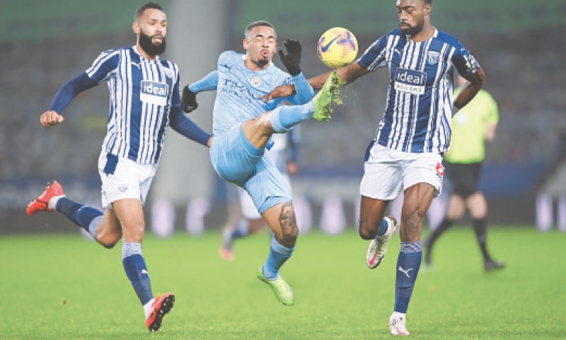 WEST BROMWICH: Manchester City’s Gabriel Jesus (C) vies for the ball with West Bromwich Albion’s Semi Ajayi (L) and Kyle Bartley during their Premier League match at the Hawthorns.—Reuters