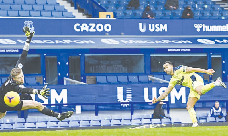 LIVERPOOL: Callum Wilson of Newcastle United scores his side&rsquo;s second goal past Everton goalkeeper Jordan Pickford during their English Premier League match at Goodison Park on Saturday.&mdash;AP
