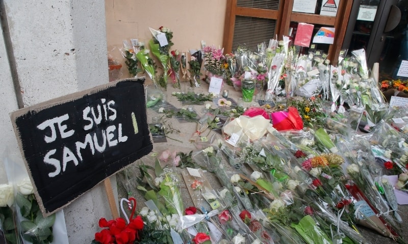 In this Oct.17, 2020 file photo, a poster reading “I am Samuel” and flowers lay outside the school where slain history teacher Samuel Paty was working, in Conflans-Sainte-Honorine, northwest of Paris. — AP In this Oct.17, 2020 file photo, a poster reading “I am Samuel” and flowers lay outside the school where slain history teacher Samuel Paty was working, in Conflans-Sainte-Honorine, northwest of Paris. — AP