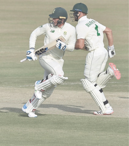 SOUTH African batsmen Rassie van der Dussen (L) and Aiden Markram run between the wickets during the second Test.—White Star