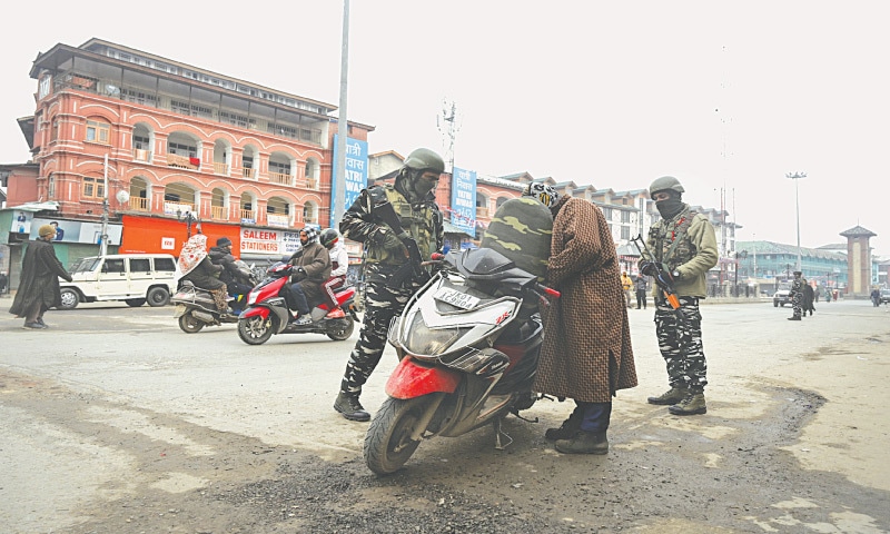 SRINAGAR: Indian security personnel search a scooter at a checkpoint during the strike on Tuesday.—AFP SRINAGAR: Indian security personnel search a scooter at a checkpoint during the strike on Tuesday.—AFP