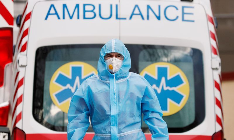 A medical worker wearing protective gear stands next to an ambulance outside a hospital for patients infected with the coronavirus disease in Kyiv, Ukraine, November 24, 2020. — Reuters