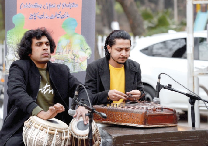 Sajawal Khan on tabla and Ali Raza on santoor perform in Kohsar Market in Islamabad on Sunday. &mdash; White Star