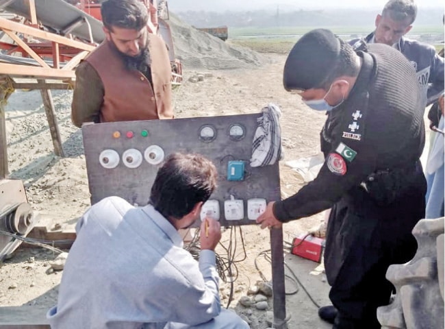 An official seals a stone-crushing plant in Bajaur. &mdash; Dawn