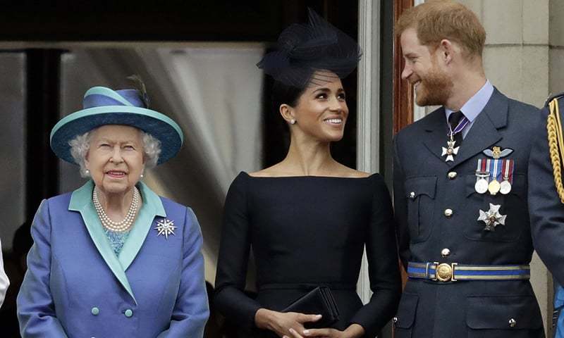 In this Tuesday, July 10, 2018 file photo Britain's Queen Elizabeth II, and Meghan the Duchess of Sussex and Prince Harry watch a flypast of Royal Air Force aircraft pass over Buckingham Palace in London. &mdash; AP/File
