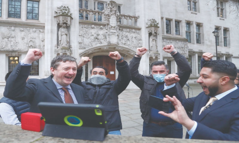 LONDON: Uber drivers belonging to the App Drivers & Couriers Union celebrate after listening to the judgement in front of the Supreme Court on Friday. &mdash;AP
