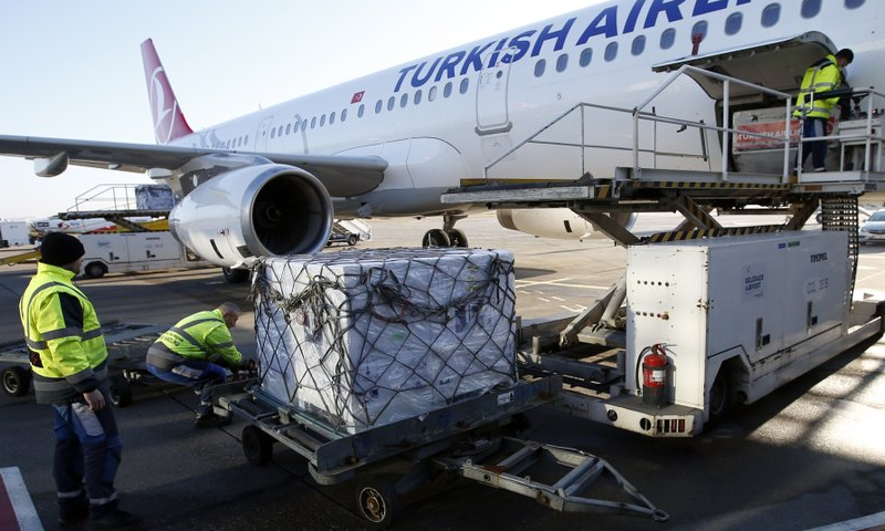 Workers unload boxes of the AstraZeneca vaccine at the Belgrade Airport, Serbia, February 21. — AP