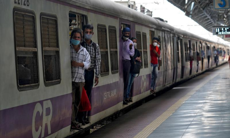 Commuters wearing protective face masks travel in a suburban train after authorities resumed the train services for all commuters in Mumbai, India. — Reuters/File