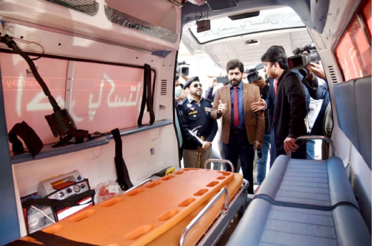 Communications Minister Murad Saeed and PRCS Chairman Abrarul Haq in conversation during the ambulance handing over ceremony in Islamabad on Wednesday. &mdash; APP