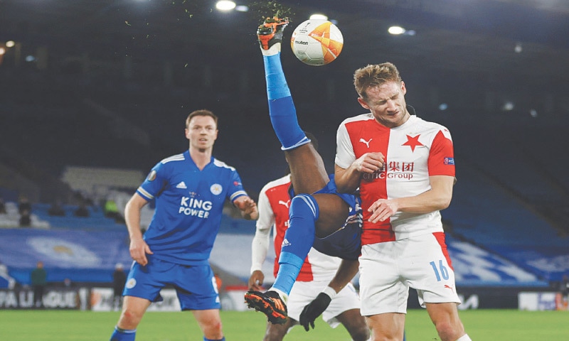 LEICESTER: Leicester City’s Daniel Amartey clears the ball with an overhead kick under pressure from Slavia Prague’s Jan Kuchta (R) during their Europa League round-of-32 second leg at the King Power Stadium.—AFP