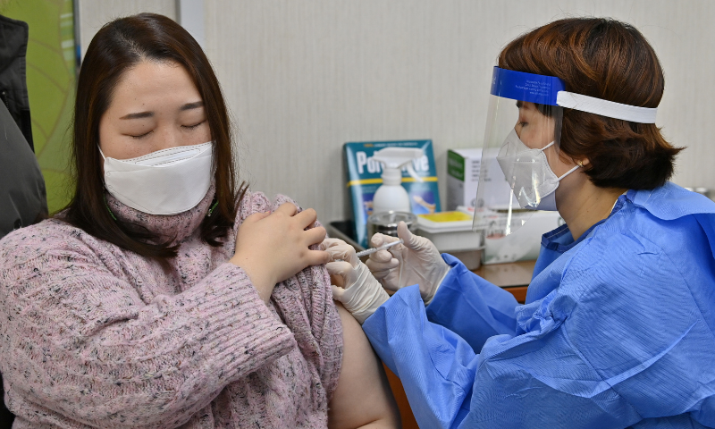 A nursing home worker (L) receives the first dose of the AstraZeneca Covid-19 vaccine at a health care centre in Seoul on Friday. &mdash; Reuters