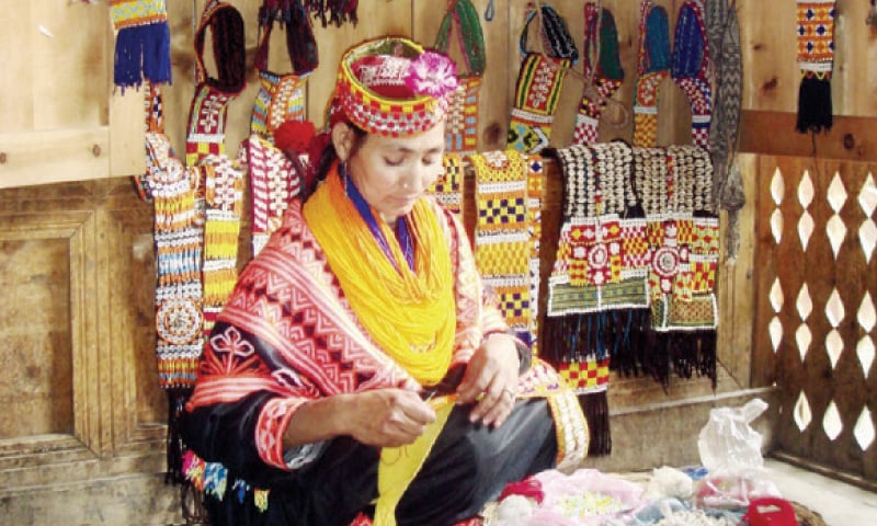 A women makes a traditional Kalash dress in her small shop. — Courtesy AKDN