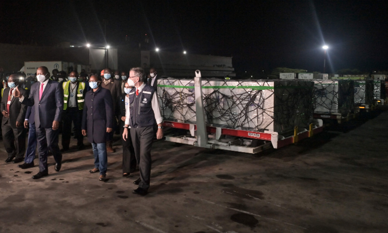 Kenya's Health Cabinet Secretary Mutahi Kagwe (2ndL) inspects the first batch of Covid-19 vaccines after they've been unloaded from a Qatar Airways flight at the Jomo Kenyatta International Airport, in Nairobi. &mdash; AFP