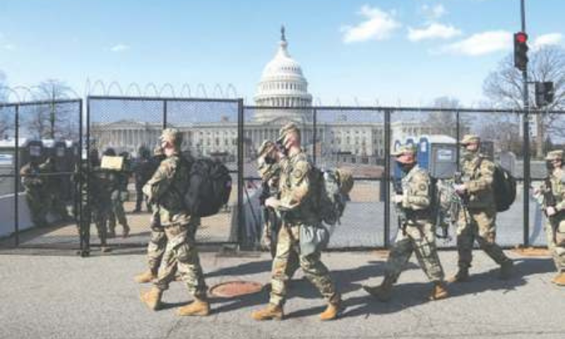 NATIONAL Guard soldiers patrol the grounds of the US Capitol on Thursday. — Reuters NATIONAL Guard soldiers patrol the grounds of the US Capitol on Thursday. — Reuters