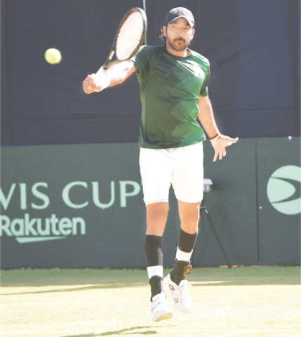 ISLAMABAD: Pakistan’s Aisam-ul-Haq hits a return to Uchida Kaichi of Japan during their singles match in the Davis Cup World Group-I tie at the Pakistan Sports Complex on Friday.—Tanveer Shahzad/White Star