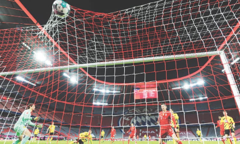MUNICH: Bayern Munich&rsquo;s Robert Lewandowski (fourth R) scores during the Bundesliga match against Borussia Dortmund at the Allianz Arena.&mdash;Reuters
