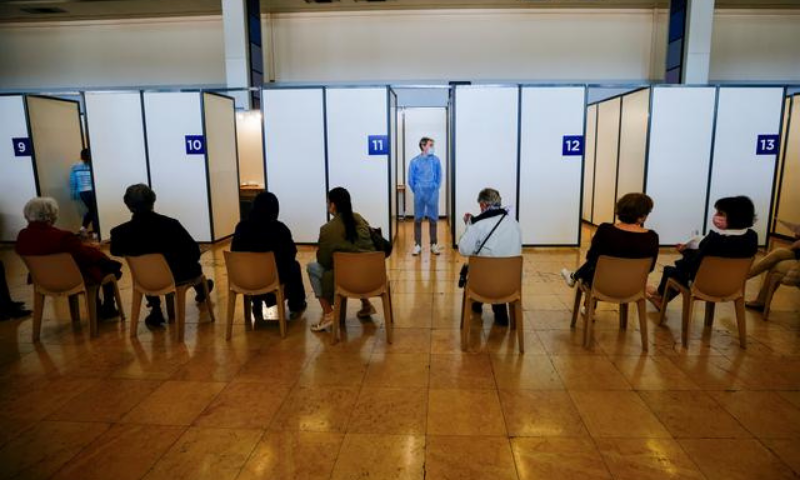 People wait to get the Pfizer-BioNTech Covid-19 vaccine in a vaccination centre inside the exhibition palace as part of the coronavirus vaccination campaign in Nice, France. — Reuters