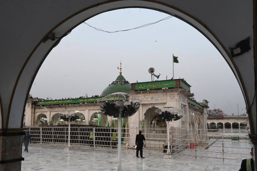 A private security guard stands at the Data Darbar shrine of Sufi saint Syed Ali bin Osman Al-Hajvery, popularly known as Data Ganj Bakhsh, after the government closed the shrine as a preventive measure against the Covid-19 coronavirus, in Lahore on March 14. — AFP