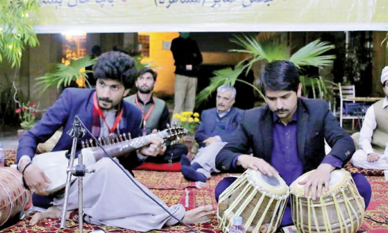 A student plays rabab at the poetic session in Peshawar on Monday. — Dawn A student plays rabab at the poetic session in Peshawar on Monday. — Dawn