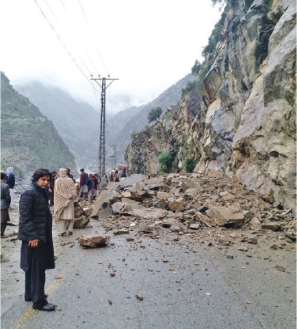 Passengers wait for reopening of road in Upper Kohistan on Sunday. &mdash; Dawn