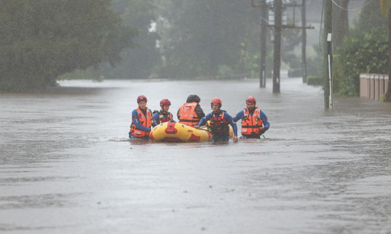 A RESCUE team uses an inflatable raft to bring a person to safety from a flooded home.—Reuters A RESCUE team uses an inflatable raft to bring a person to safety from a flooded home.—Reuters