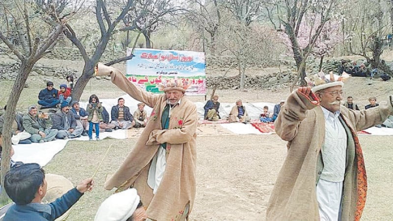 GHIZER: Elders dance to the tune of traditional music during an event organised to celebrate Nauroz at Damas village in Ghizer on Sunday.—Dawn