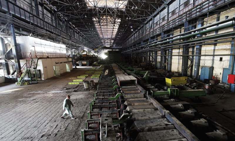 In this Feb 8, 2016 picture, a man walks past machines at the hot strip mill department of the Pakistan Steel Mills. — Reuters/File