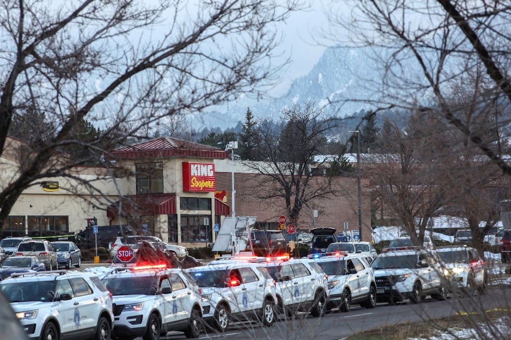 Law enforcement vehicles line up at the perimeter of a shooting site at a King Soopers grocery store in Boulder, Colorado, on March 22. &mdash; Reuters